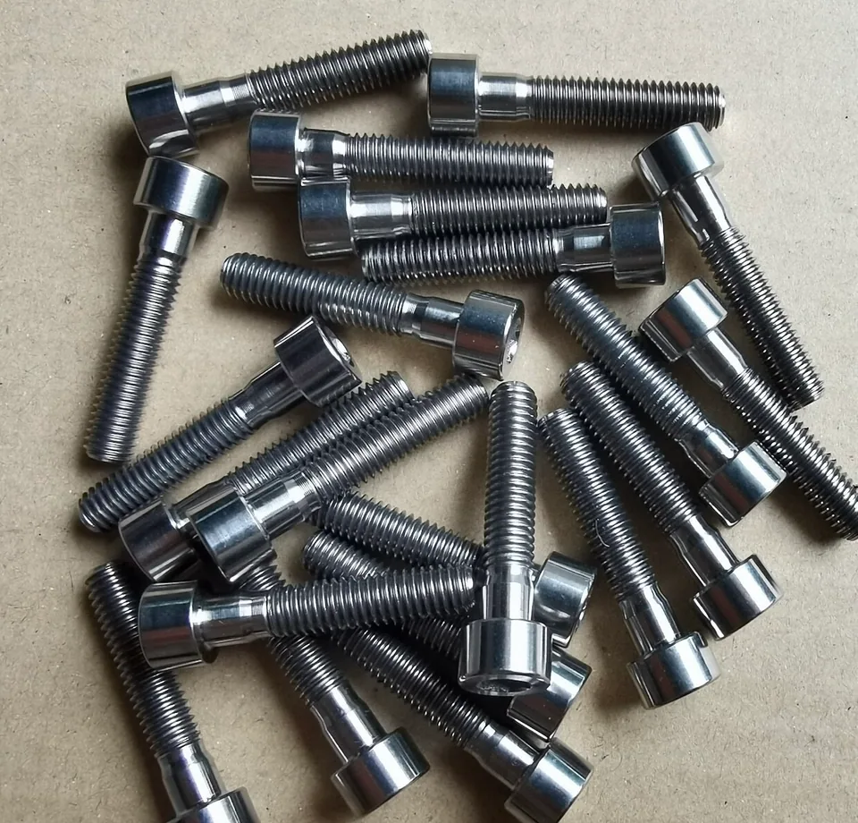 Reference photograph of titanium socket-head bolts with shoulders and threaded shanks
