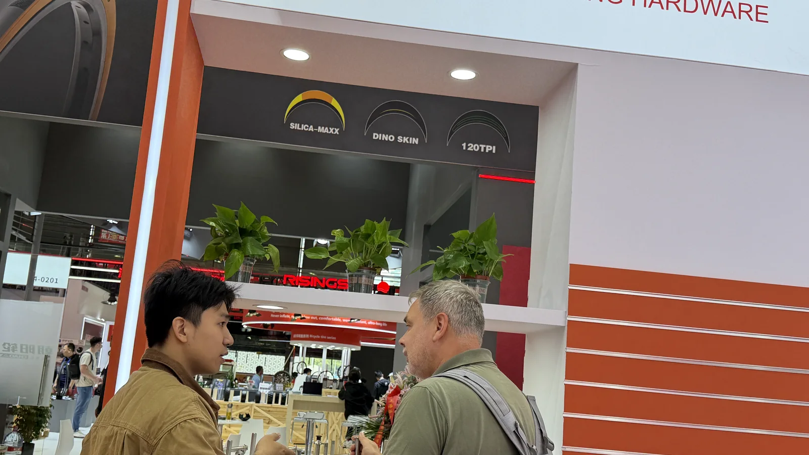 Technical product discussion between PremFixer staff and a trade-show visitor