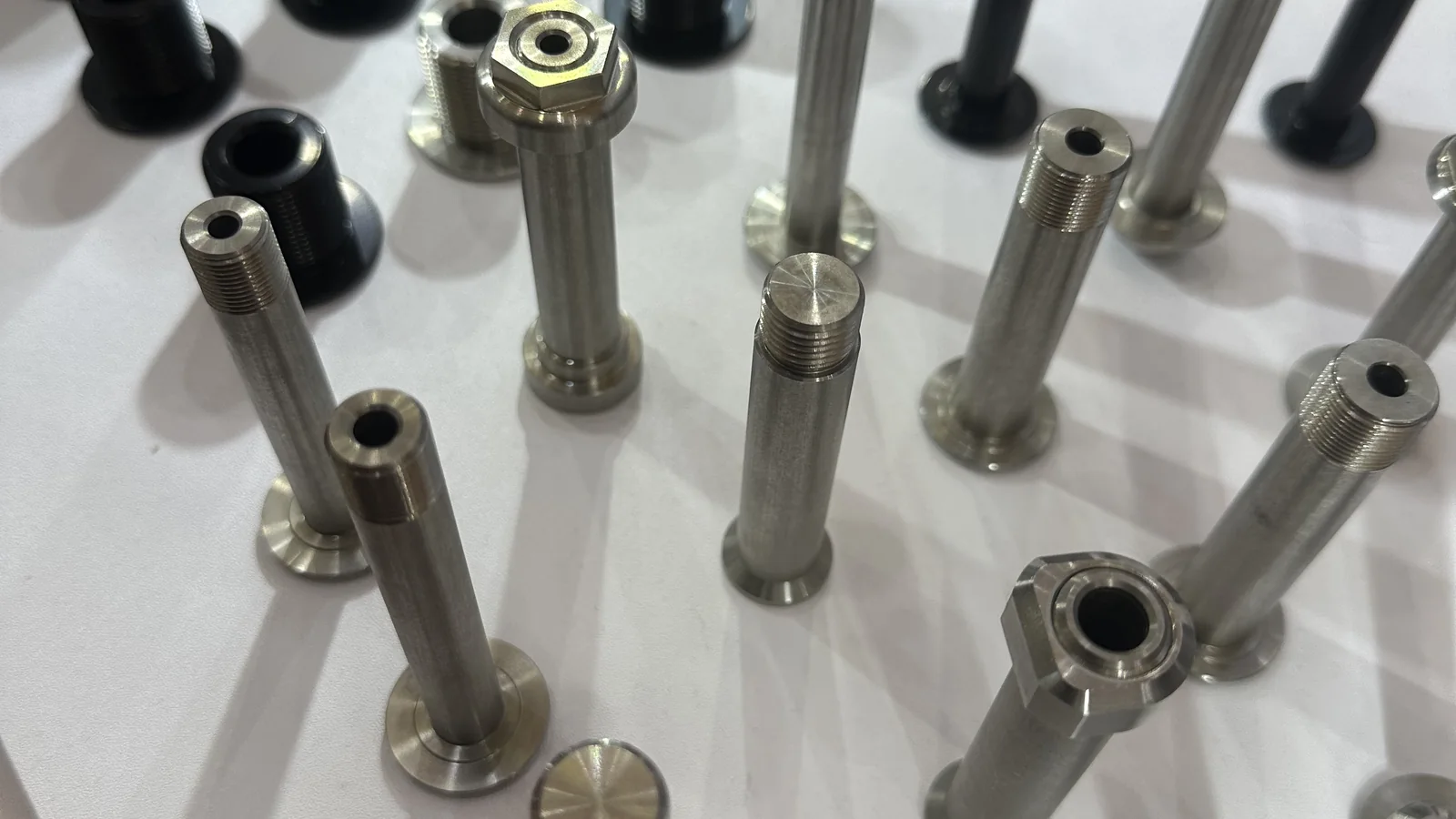 CNC-machined bicycle pivot bolts and custom fasteners displayed by PremFixer