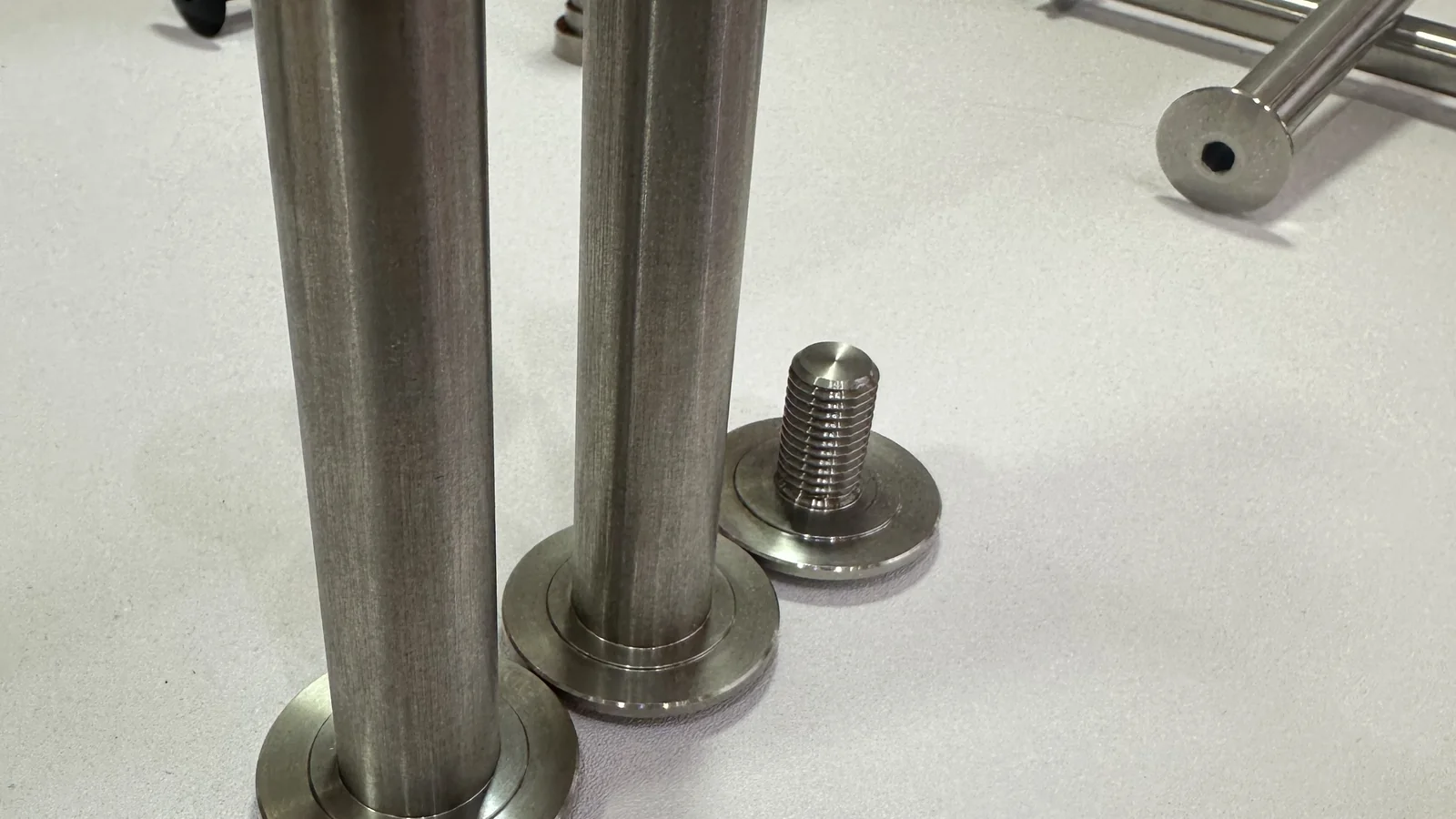 Four-bar linkage pivot bolt systems displayed at a bicycle industry event
