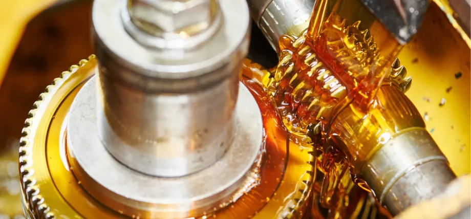 Close up of meshed spur gears undergoing gear hobbing
